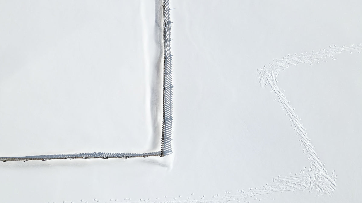 a white sheet with a line drawn in the snow