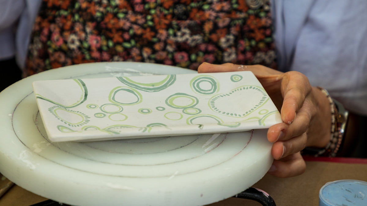 a person holding a white plate