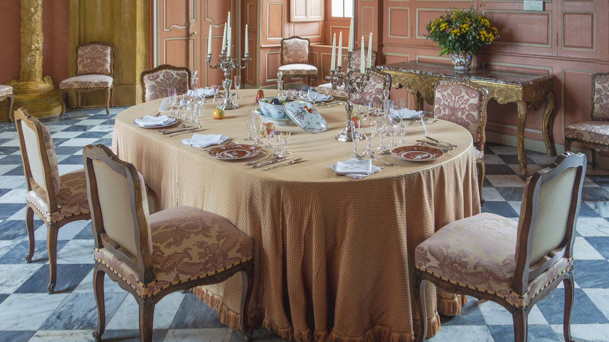 a dining table with plates and glasses on it