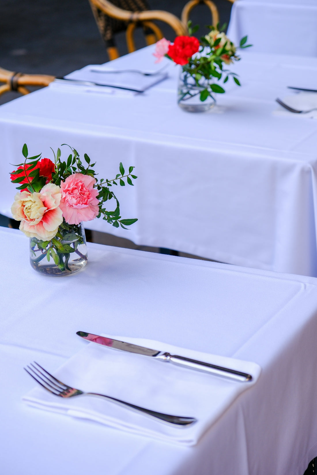 a table with two vases of flowers on top of it