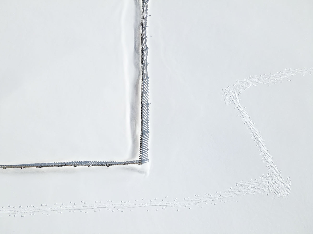 a white sheet with a line drawn in the snow