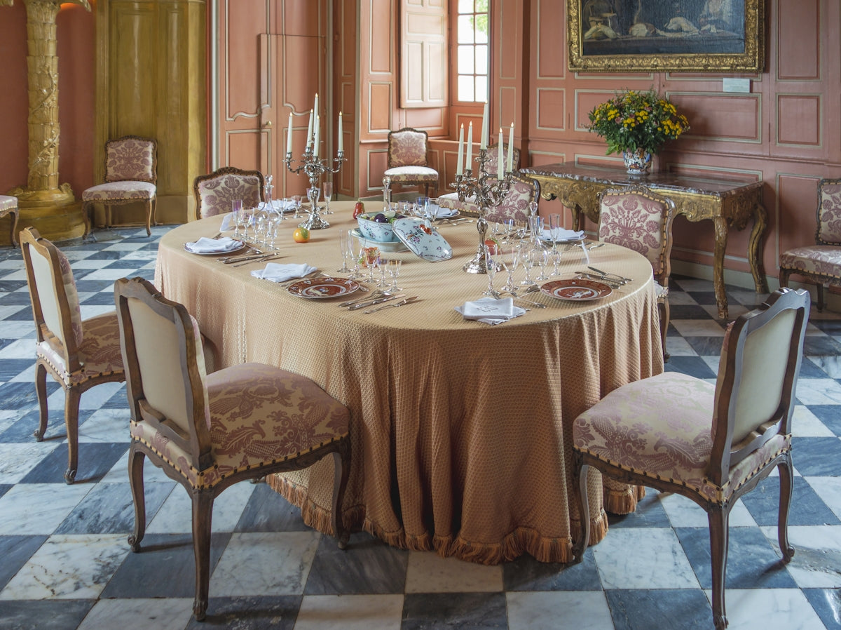 a dining table with plates and glasses on it