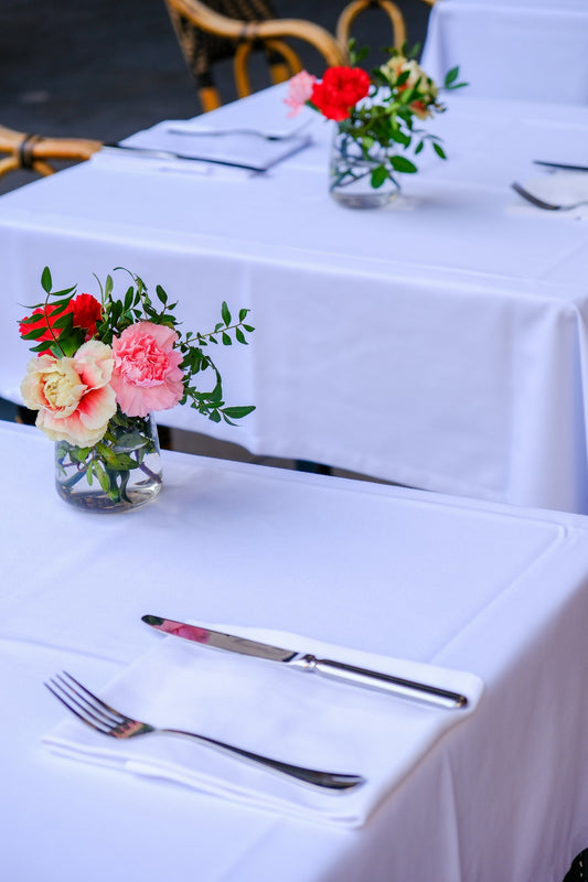 a table with two vases of flowers on top of it