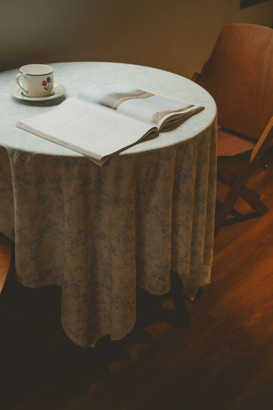 A table with a book and a cup on it