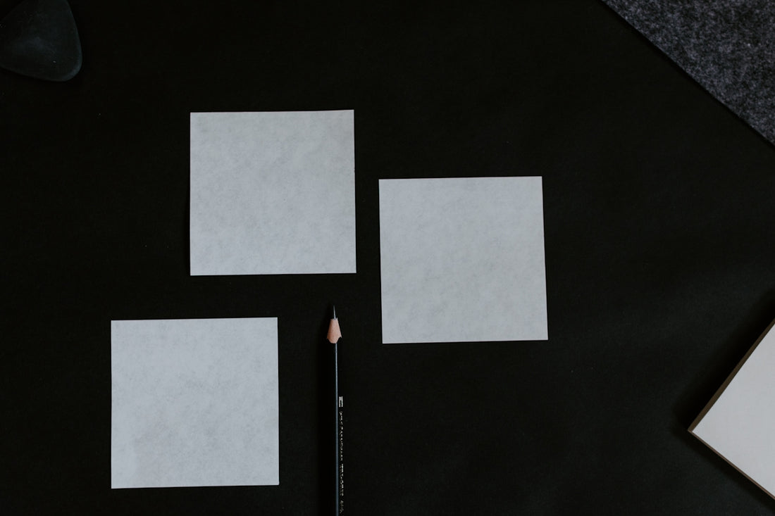 A black table topped with a pencil and paper
