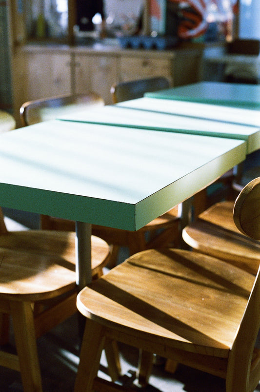 A group of wooden chairs sitting next to each other