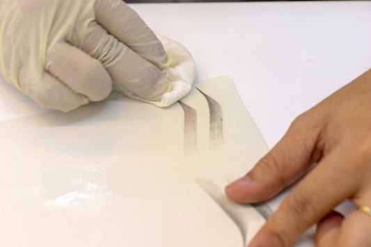 A person wearing gloves is using a computer mouse